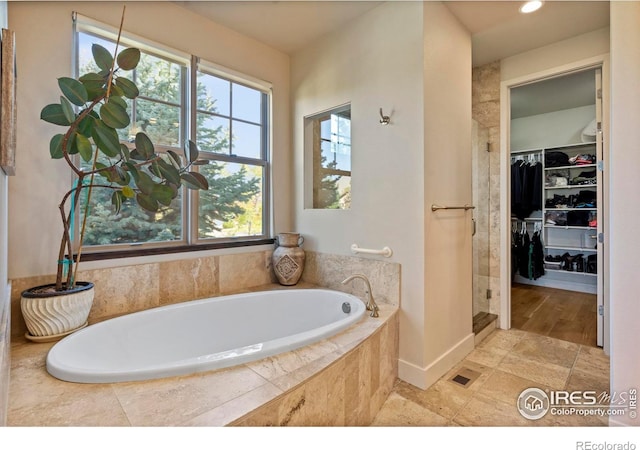 5112 Daylight Ct, Fort Collins, CO 80528 - bathroom with a shower stall, a bath, a walk in closet, and recessed lighting