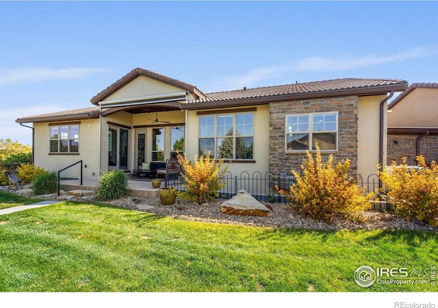 5112 Daylight Ct, Fort Collins, CO 80528 - back of property featuring a ceiling fan, a yard, a patio area, and stucco siding