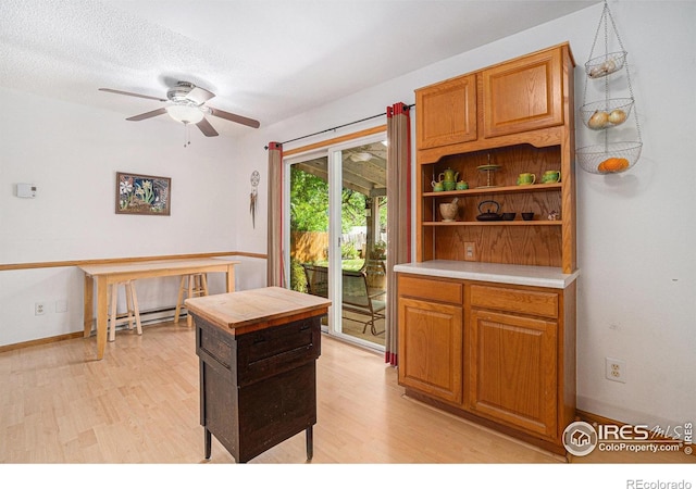 4117 Shannon Dr, Laporte, CO 80535 - kitchen featuring light wood-style flooring, ceiling fan, open shelves, and brown cabinetry