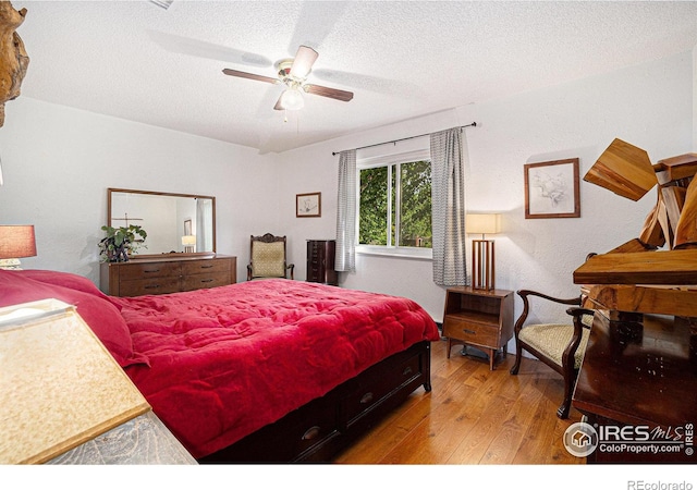 4117 Shannon Dr, Laporte, CO 80535 - bedroom featuring wood finished floors, a textured ceiling, and a ceiling fan