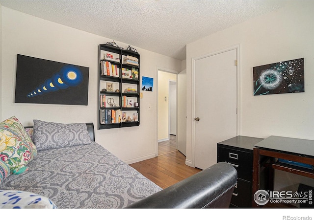 4117 Shannon Dr, Laporte, CO 80535 - bedroom featuring wood finished floors, a textured ceiling, and baseboards
