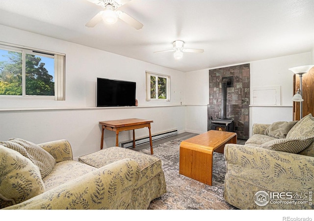 4117 Shannon Dr, Laporte, CO 80535 - living area with a baseboard heating unit, ceiling fan, and a wood stove