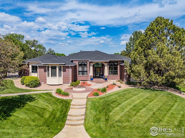 13 Blue Heron Dr, Thornton, CO 80241 - view of front of property featuring brick siding, a front lawn, and a shingled roof