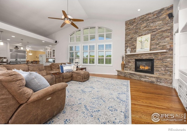 13 Blue Heron Dr, Thornton, CO 80241 - living area with ceiling fan, wood finished floors, a fireplace, high vaulted ceiling, and recessed lighting