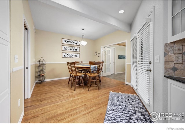 13 Blue Heron Dr, Thornton, CO 80241 - dining space featuring light wood-type flooring, beam ceiling, french doors, and baseboards