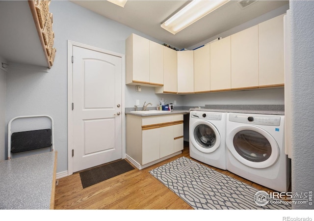 13 Blue Heron Dr, Thornton, CO 80241 - laundry area with cabinet space, washing machine and clothes dryer, and light wood-style floors