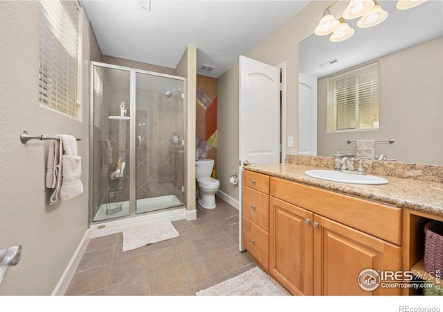 13 Blue Heron Dr, Thornton, CO 80241 - full bathroom featuring vanity, toilet, a stall shower, and baseboards