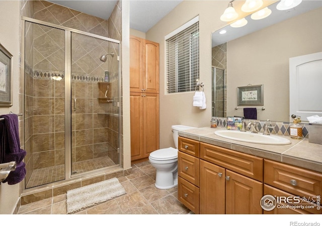 13 Blue Heron Dr, Thornton, CO 80241 - full bathroom featuring vanity, toilet, and a shower stall