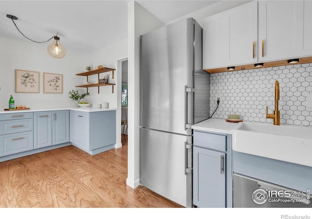 790 W Moorhead Cir # A, Boulder, CO 80305 - kitchen featuring freestanding refrigerator, light wood-style flooring, a sink, light countertops, and backsplash