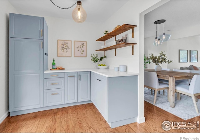 790 W Moorhead Cir # A, Boulder, CO 80305 - kitchen with open shelves, light wood-type flooring, light countertops, hanging light fixtures, and blue cabinetry