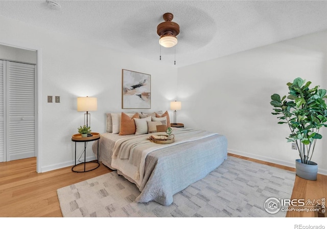 790 W Moorhead Cir # A, Boulder, CO 80305 - bedroom featuring wood finished floors, baseboards, a textured ceiling, and ceiling fan