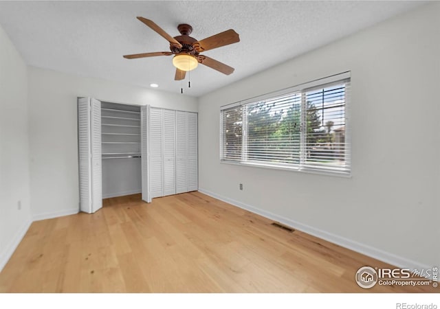 790 W Moorhead Cir # A, Boulder, CO 80305 - unfurnished bedroom featuring wood finished floors, two closets, baseboards, and a ceiling fan