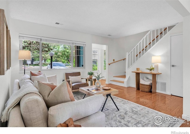 790 W Moorhead Cir # A, Boulder, CO 80305 - living room with wood finished floors, stairs, healthy amount of natural light, and a textured ceiling