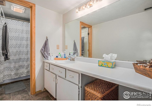 2525 S Dayton Way Unit 2301, Denver, CO 80231 - full bath with vanity, tile patterned flooring, and a shower with shower curtain