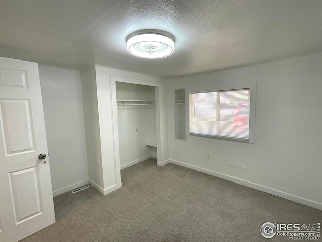 522 K Ave, Limon, CO 80828 - unfurnished bedroom with carpet floors, baseboards, a closet, and a textured ceiling