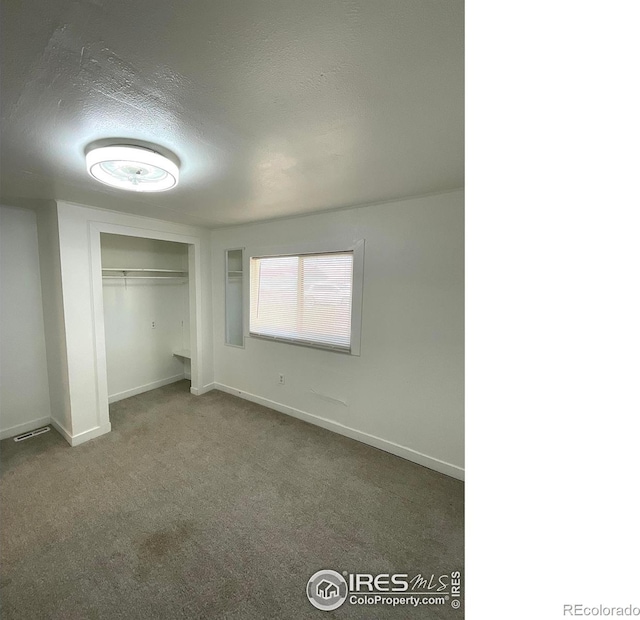 522 K Ave, Limon, CO 80828 - unfurnished bedroom with a textured ceiling, carpet floors, baseboards, and a closet