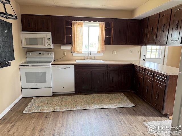 302 Cedar Ave, Akron, CO 80720 - kitchen with white appliances, a sink, open shelves, and light countertops