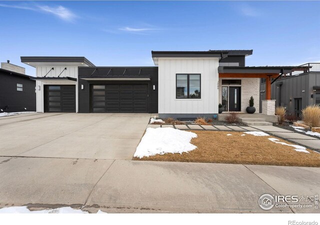 2089 Picture Pointe Dr, Windsor, CO 80550 - view of front of house with an attached garage, board and batten siding, and concrete driveway