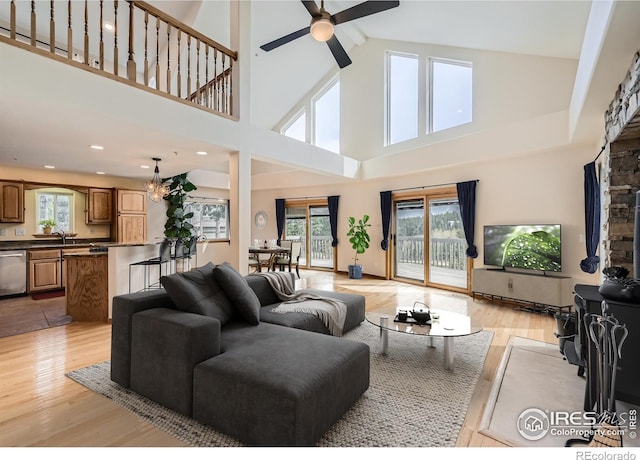 613 Ranch Rd, Ward, CO 80481 - living room with light wood-style floors, a ceiling fan, and a towering ceiling