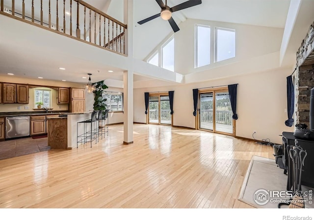 613 Ranch Rd, Ward, CO 80481 - unfurnished living room with ceiling fan, light wood-style flooring, a towering ceiling, a sink, and recessed lighting