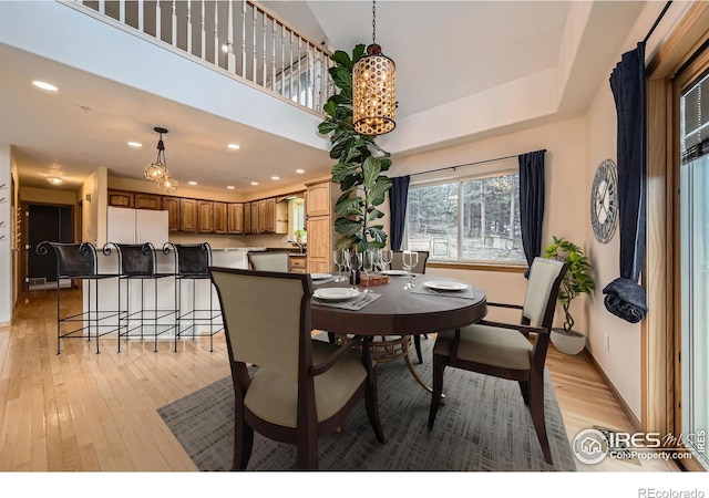 613 Ranch Rd, Ward, CO 80481 - dining space featuring light wood-type flooring, baseboards, a chandelier, recessed lighting, and a high ceiling