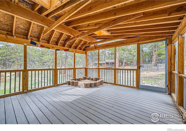 613 Ranch Rd, Ward, CO 80481 - unfurnished sunroom featuring a wooden deck, lofted ceiling, view of wooded area, and hardwood / wood-style flooring