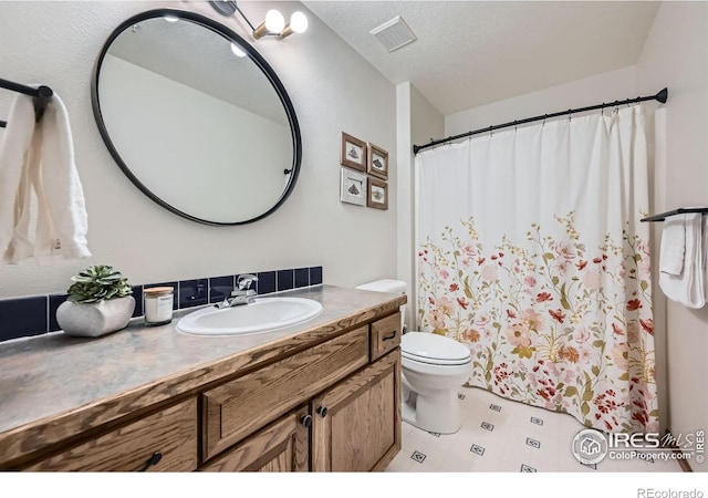 613 Ranch Rd, Ward, CO 80481 - full bathroom with vanity, toilet, a textured ceiling, and a shower with curtain