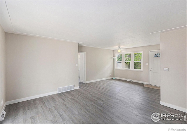 2116 16th St, Greeley, CO 80631 - empty room featuring ceiling fan, wood finished floors, and baseboards