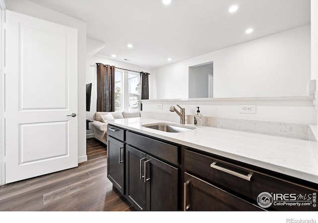 926 Hearteye Trl, Lafayette, CO 80026 - kitchen featuring a sink, dark wood-type flooring, recessed lighting, light stone countertops, and open floor plan