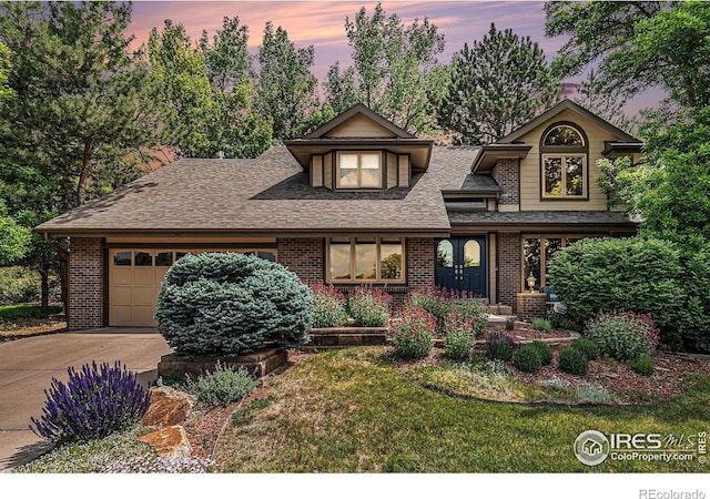3441 W Dartmouth Ave, Denver, CO 80236 - view of front of property featuring a garage, concrete driveway, brick siding, and roof with shingles