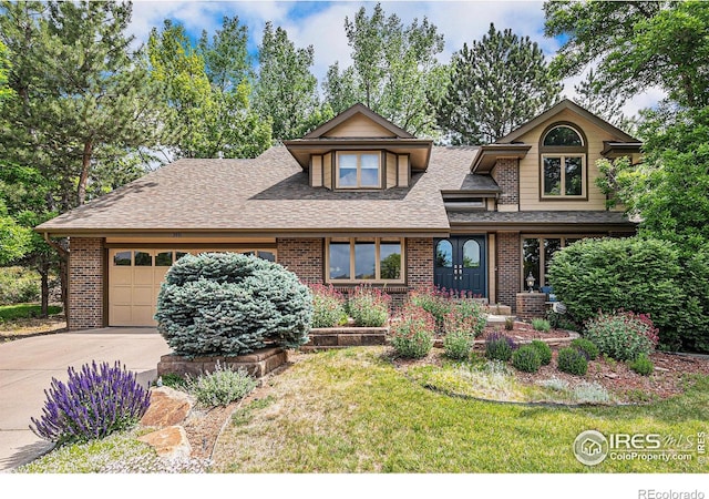 3441 W Dartmouth Ave, Denver, CO 80236 - view of front of house featuring a garage, brick siding, concrete driveway, a shingled roof, and a front yard