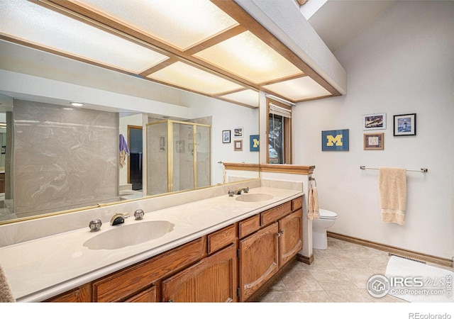 3441 W Dartmouth Ave, Denver, CO 80236 - full bath with toilet, a stall shower, double vanity, baseboards, and tile patterned flooring