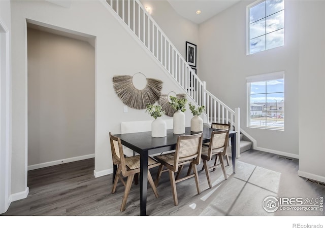 945 Abbott Ln Unit 5, Fort Collins, CO 80524 - dining room featuring stairway, wood finished floors, baseboards, a high ceiling, and recessed lighting