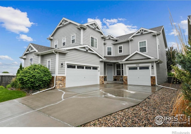 2315 Haymeadow Way, Fort Collins, CO 80525 - craftsman inspired home with an attached garage, driveway, stone siding, and a shingled roof