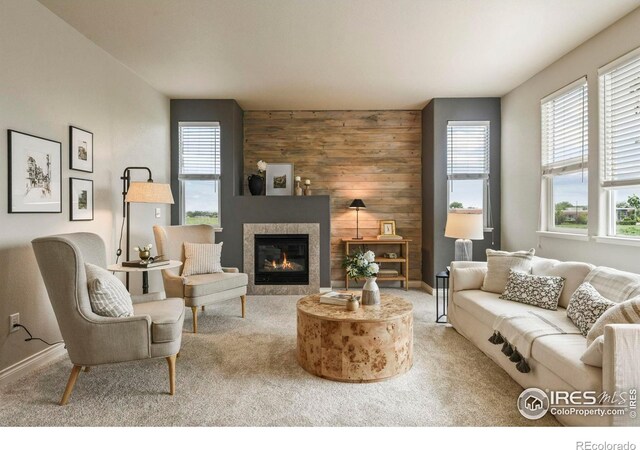 2315 Haymeadow Way, Fort Collins, CO 80525 - living area with carpet floors, wooden walls, a tiled fireplace, and baseboards
