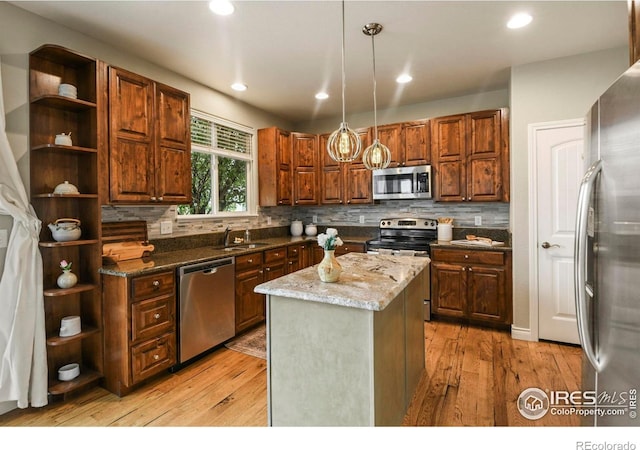 2315 Haymeadow Way, Fort Collins, CO 80525 - kitchen featuring appliances with stainless steel finishes, open shelves, light wood-type flooring, and recessed lighting