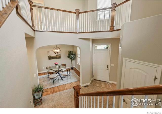 2315 Haymeadow Way, Fort Collins, CO 80525 - entrance foyer featuring arched walkways, a towering ceiling, and baseboards