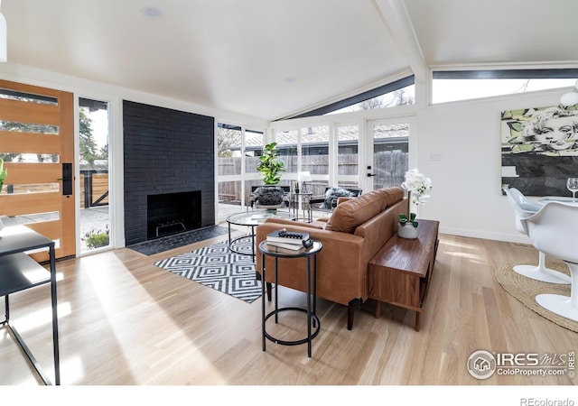 2435 S Meade St, Denver, CO 80219 - living room featuring wood finished floors and a fireplace