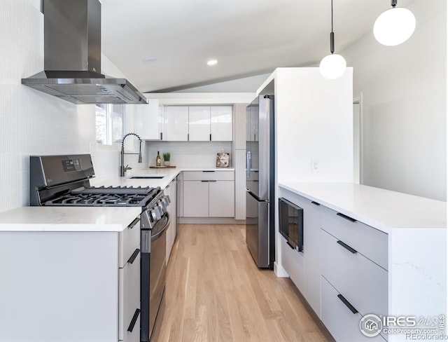 2435 S Meade St, Denver, CO 80219 - kitchen with stainless steel appliances, wall chimney exhaust hood, light wood finished floors, modern cabinets, and a sink