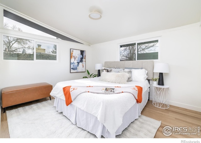 2435 S Meade St, Denver, CO 80219 - bedroom featuring lofted ceiling, wood finished floors, and baseboards