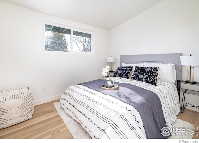 2435 S Meade St, Denver, CO 80219 - bedroom featuring wood finished floors, baseboards, and lofted ceiling