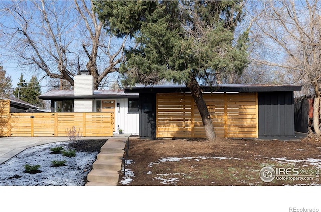 2435 S Meade St, Denver, CO 80219 - mid-century inspired home featuring a chimney and board and batten siding