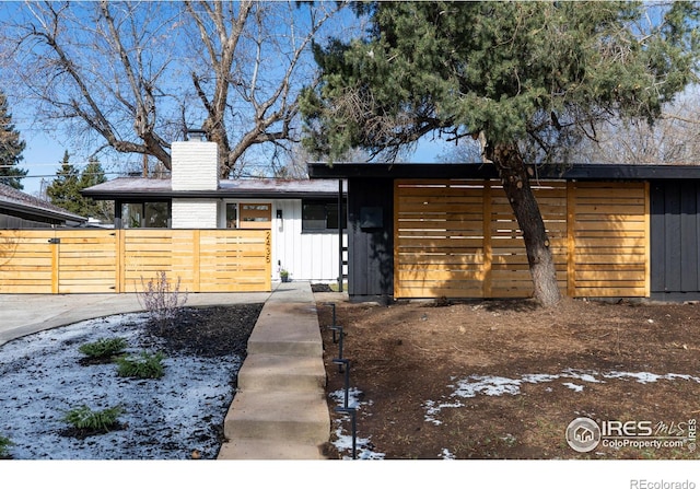 2435 S Meade St, Denver, CO 80219 - mid-century inspired home featuring board and batten siding and a chimney