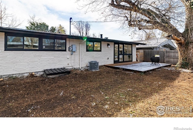 2435 S Meade St, Denver, CO 80219 - rear view of house with central AC and a wooden deck