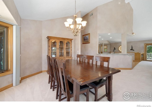 6239 Ashcroft Rd, Greeley, CO 80634 - dining space with light carpet, a chandelier, baseboards, and high vaulted ceiling