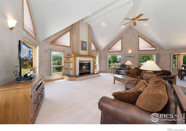 6239 Ashcroft Rd, Greeley, CO 80634 - living area with high vaulted ceiling, light carpet, a tile fireplace, a ceiling fan, and beamed ceiling