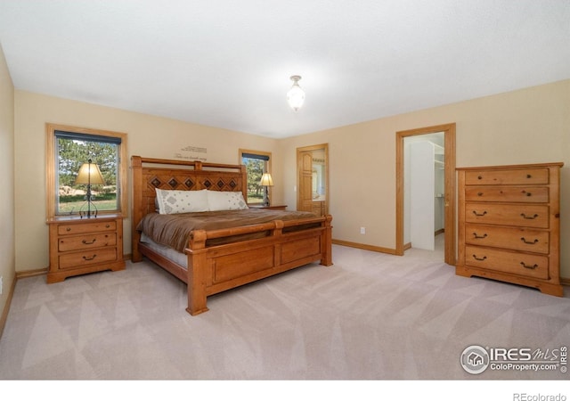 6239 Ashcroft Rd, Greeley, CO 80634 - bedroom with light colored carpet, multiple windows, and baseboards