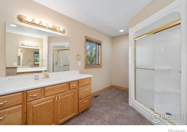 6239 Ashcroft Rd, Greeley, CO 80634 - bathroom featuring vanity, a stall shower, baseboards, and tile patterned flooring
