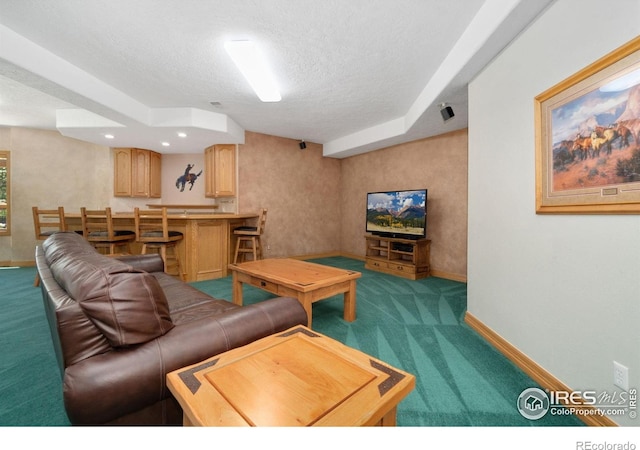 6239 Ashcroft Rd, Greeley, CO 80634 - carpeted living room featuring a textured ceiling, baseboards, and bar area