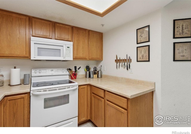 2802 Sundown Ln Unit 102, Boulder, CO 80303 - kitchen with white appliances, light countertops, and brown cabinets